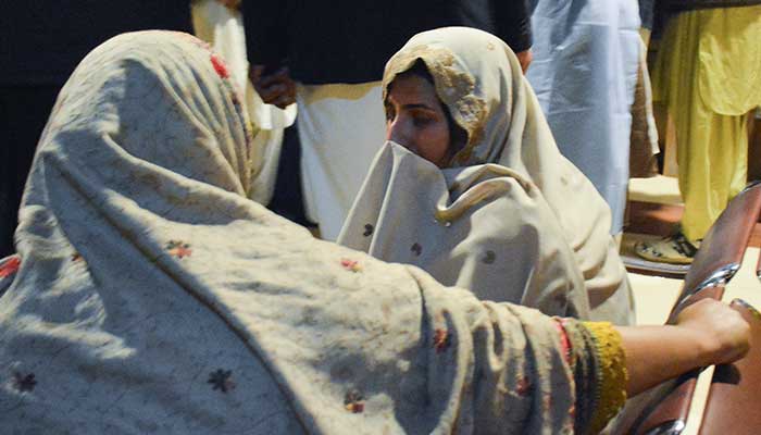 Passengers who were saved from a train after being attacked by activists sit at Quetta station, Balutchistan, March 12, 2025. - Reuters 