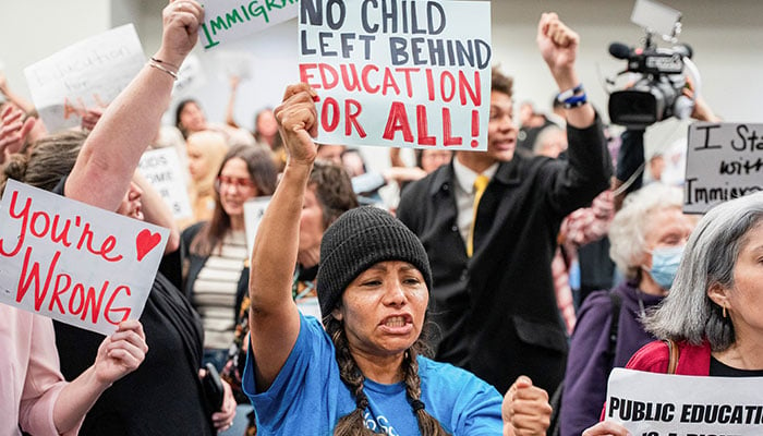 People hold signs during a rally at Cordell Hull State Office building in Nashville, Tennessee, US on March 11, 2025. — Reuters