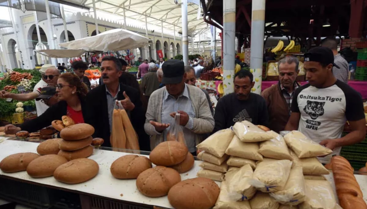 Tunisians buy bread at a market in Tunis during the first day of Ramadan. — AFP/File