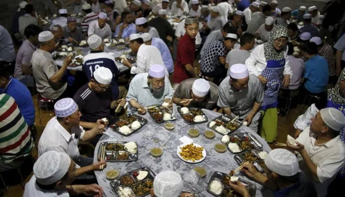 Men are gathered around a traditional iftar spread in Uzbekistan. — El-Shai/File