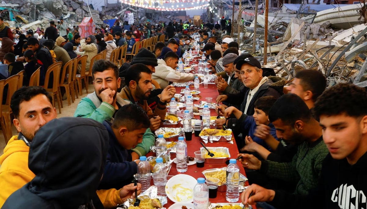 Palestinians break their fast by eating the Iftar meals during the holy month of Ramadan, near the rubble of buildings, amid a ceasefire between Israel and Hamas, in Rafah, in the southern Gaza Strip, March 1, 2025. — Reuters