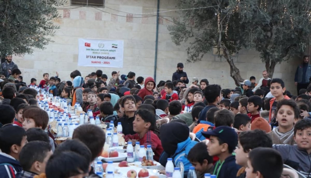 Children are seated before an iftar spread prepared for them on a table in Syria. — Instagram/@humanitarianrelief