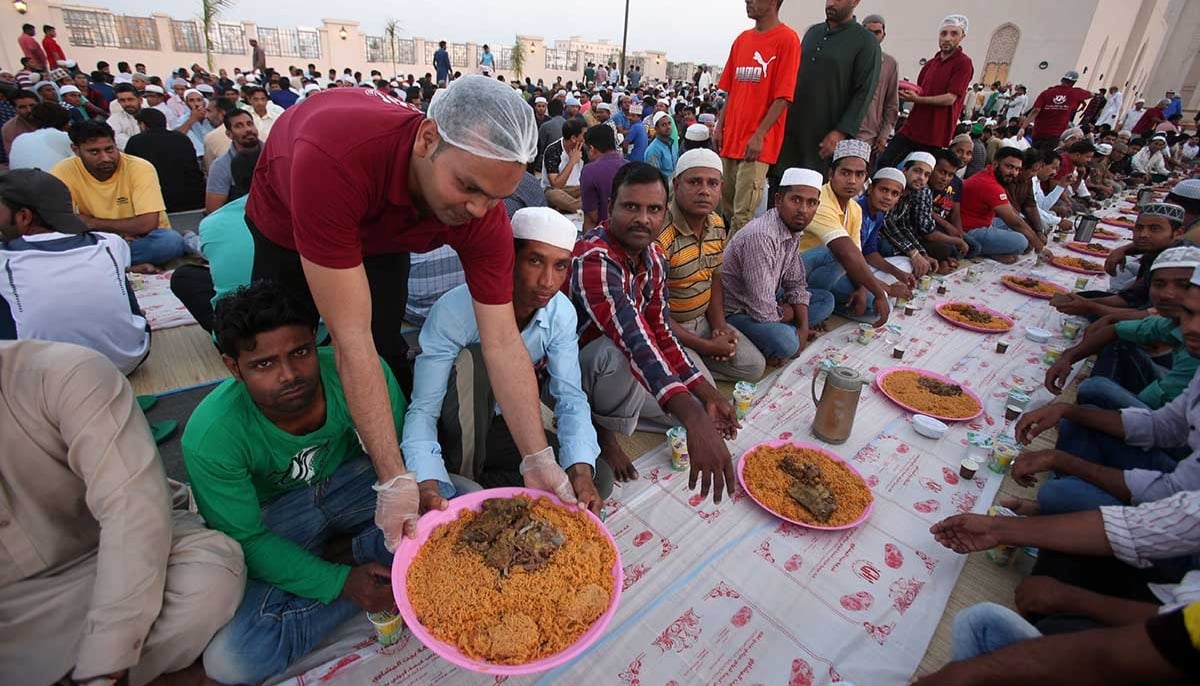 Muslim devotees share an iftar dinner in front of the Sayeda Fatima mosque in the Omani capital Muscat on May 19, 2018. — Arabian Business