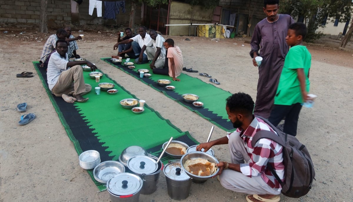 Displaced Sudanese prepare to break their fast at a displacement camp during the month of Ramadan, in the city of Port Sudan, Sudan, March 14, 2024. — Reuters