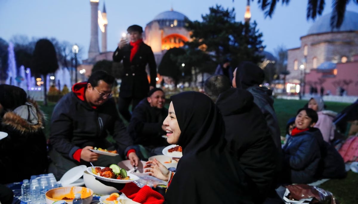 People have their iftar, or breaking fast, meal at Sultanahmet Square with the Hagia Sophia Grand Mosque in the background during the first day of Ramadan in Istanbul, Turkey, March 23, 2023. — Reuters