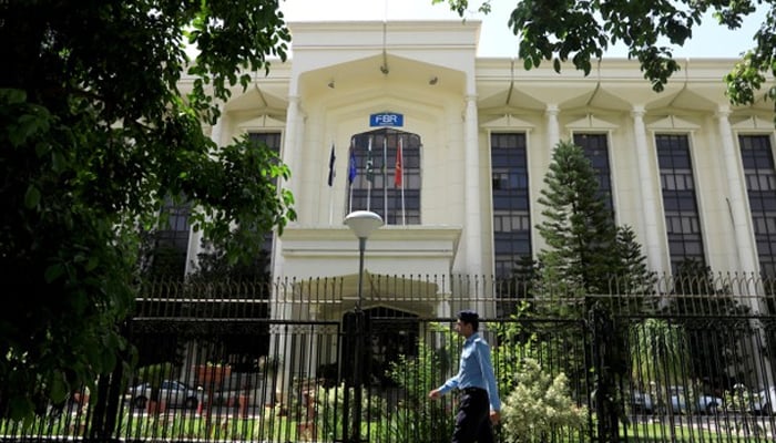 A police officer passes in front of the building of the FBR office in Islamabad, August 29, 2018. - Reuters