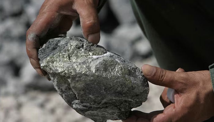 A worker holds a rock at a gold mine. — Reuters/File