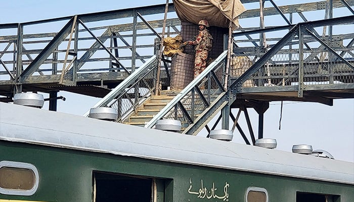 A paramilitary soldier stands guard at a railway station in the Sibi district of southwestern Balochistan province on March 12, 2025, during a security operation against militants a day after they hijacked a passenger train. — AFP