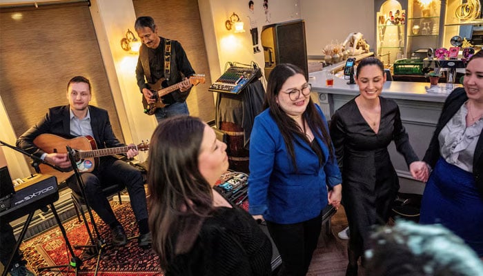 Leader of Demokraatit, Jens-Frederik Nielsen, plays an instrument during the election party at cafe Killut in Nuuk, Greenland, March 12, 2025. — Reuters