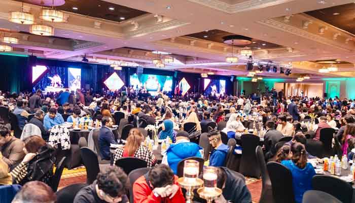 The image shows attendees at the iftar dinner. — Reporter