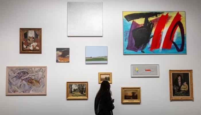 A patient, who is a part of a project in which doctors prescribe museum visits, looks at artworks in the Art and History Museum in Neuchatel, Switzerland March 11, 2025. — Reuters