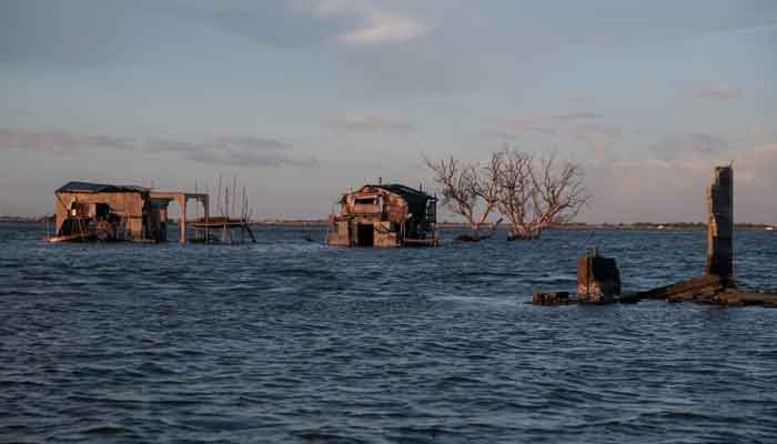 Bamboo huts sit on top of concrete structures in the submerged coastal village Sitio Pariahan, Bulakan, Bulacan, north of Manila, Philippines, on November 27, 2019. — Reuters