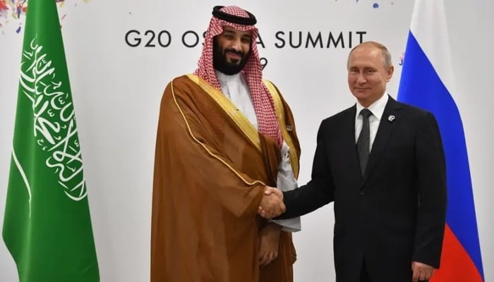 Russias President Vladimir Putin (right) shakes hands with Saudi Arabia’s Crown Prince Mohammed bin Salman during a meeting. — AFP/File