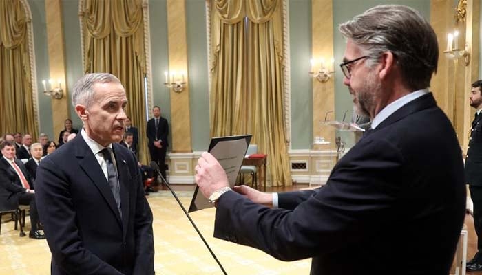 Canada’s Prime Minister-designate Mark Carney and Clerk of the Privy Council John Hannaford prepare for Mr. Carney’s swearing-in ceremony at Rideau Hall on March 14, 2025 in Ottawa.— AFP