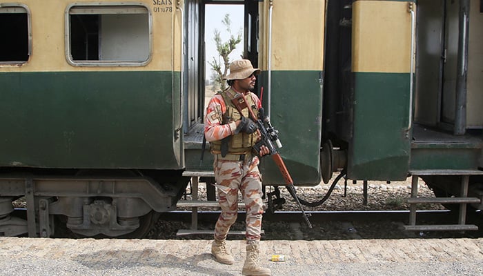 A soldier stands guard next to a rescue train, after the attack on a train by militants in Bolan, at the railway station in Mushkaf, Balochistan on March 12, 2025. — Reuters