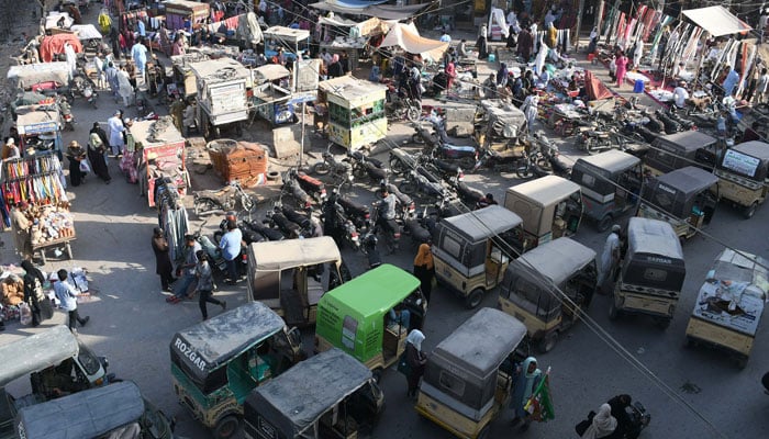 Rickshshaws are parked at Karachis Karimabad market on March 5, 2025. — Online