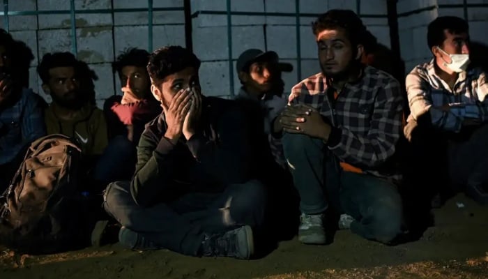 Young men awaiting transport by human smugglers. — AFP