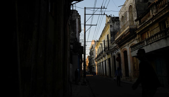 People walk on a street during a national electrical grid collapse, in Havana, Cuba, March 15, 2025. — Reuters