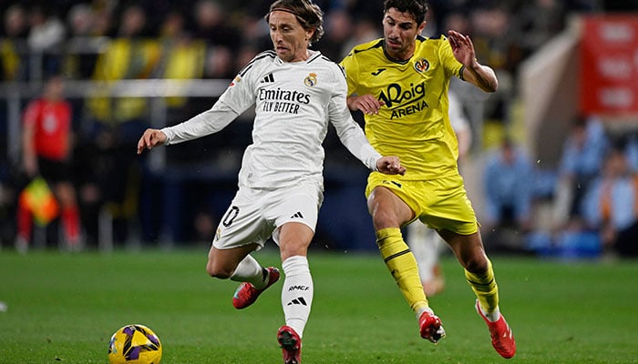 Real Madrids Luka Modric at work with Villarreals Santi Comesana at Estadio de la Ceramica, Villarreal, Spain on March 15, 2025. - Reuters