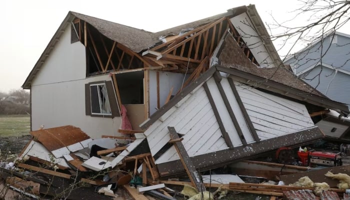 Debris lies around a damaged home the morning after a tornado touched down in Florissant, Missouri, US, March 15, 2025. — Reuters