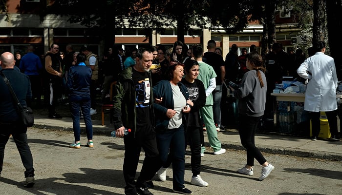 Friends and relatives of the victims gather in front of a hospital following a fire in a nightclub which killed 51 people in Kocani, a town some 100 kilometres east of the capital Skopje, on March 16, 2025 — AFP