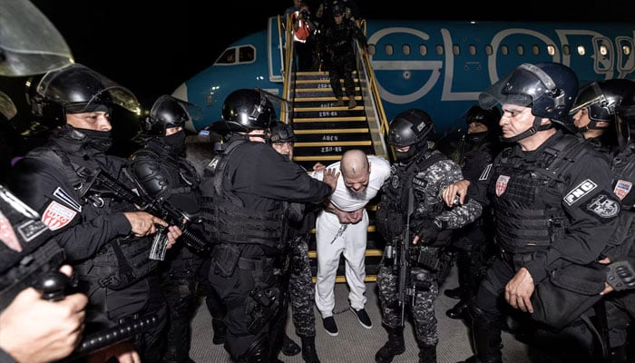 Salvadoran police escort alleged members of the Tren de Aragua. — Reuters/File