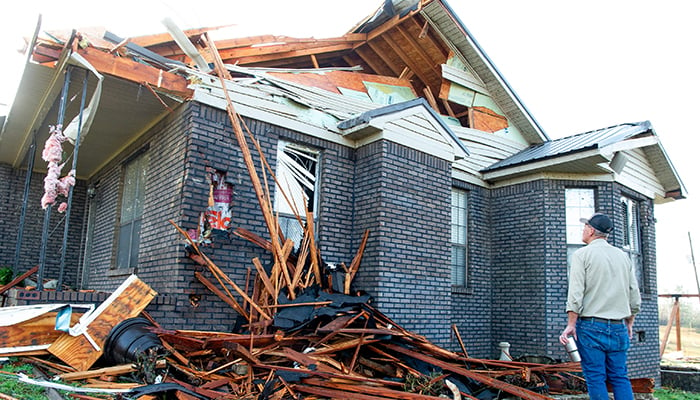 A man checks the storm damage of his home after a fatal overnight tornado hit the area in the Alpine community near Plantersville, Alabama, US, March 16, 2025. — Reuters