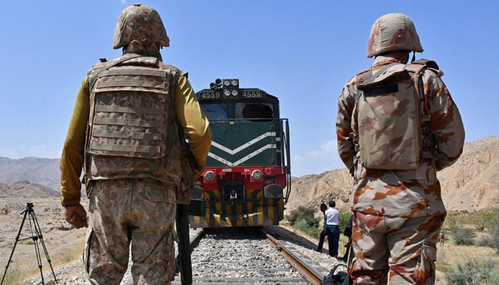 Frontier Corps soldiers stand guard at the siege site after terrorists ambushed a train in the remote mountainous area, at Pehro Kunri in Balochistan on on March 15, 2025. — AFP