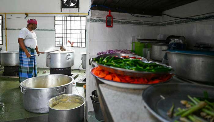 An Indian Muslim man mixes ingredients for the popular dish Bubur Lambuk at Masjid India during Ramadan in Kuala Lumpur, Malaysia on March 5, 2025. — AFP