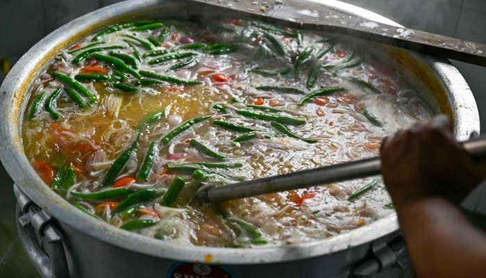 An Indian Muslim man mixes ingredients for the popular dish Bubur Lambuk at Masjid India during Ramadan in Kuala Lumpur, Malaysia on March 5, 2025. — AFP