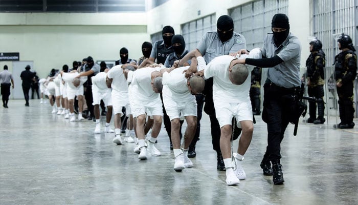 Salvadoran police officers escort alleged members of the Venezuelan gang Tren de Aragua recently deported by the US government to be imprisoned in the Terrorism Confinement Center (CECOT) prison, as part of an agreement with the Salvadoran government, in Tecoluca, El Salvador, in this handout image obtained March 16, 2025. — Reuters