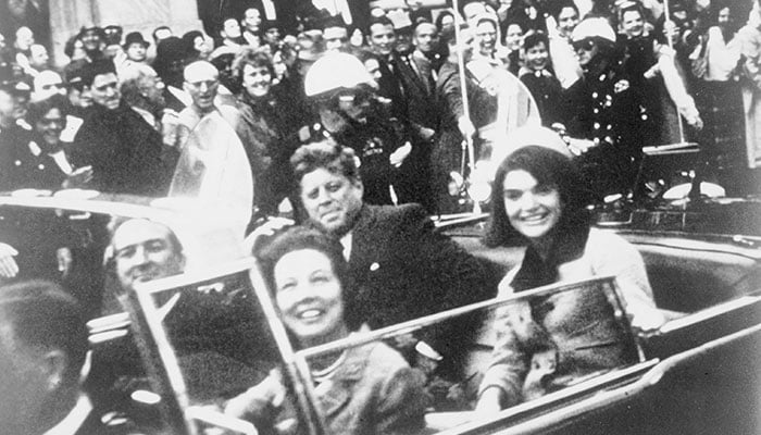 Former US President John F. Kennedy (centre), first lady Jacqueline Kennedy (right) are pictured riding in the presidential motorcade moments before Kennedy was shot in Dallas, Texas, in this handout image taken on November 22, 1963. — Reuters