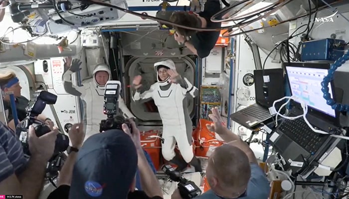 Butch Wilmore and Suni Williams, two veteran Nasa astronauts who have been stuck on the International Space Station (ISS) for nine months, wave at the hatch of a SpaceX Crew Dragon capsule before closing the hatch in preparation for undocking from the ISS to begin their return to Earth March 17, 2025 in this still image taken from video. — Reuters