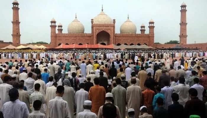 People offer Eid ul Fitr prayers at the Badshahi Mosque in Lahore. — AFP/File