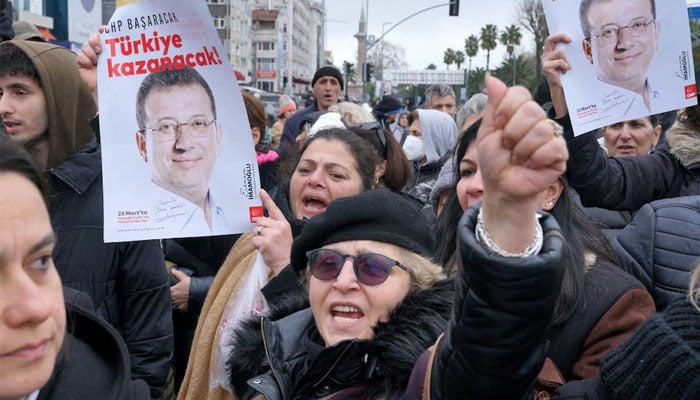 Supporters of Istanbul Mayor Ekrem Imamoglu gather near the citys police headquarters in Istanbul, Turkey, March 19, 2025. REUTERS/Tolga Uluturk Purchase Licensing Rights. — Reuters