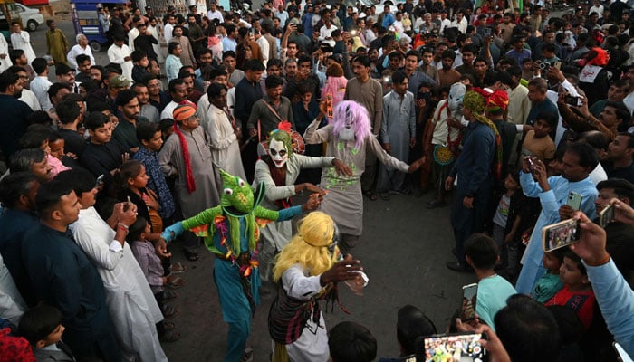 People celebrate Holi in Tharparkar district of the desert town of Mithi on March 13, 2025. — AFP