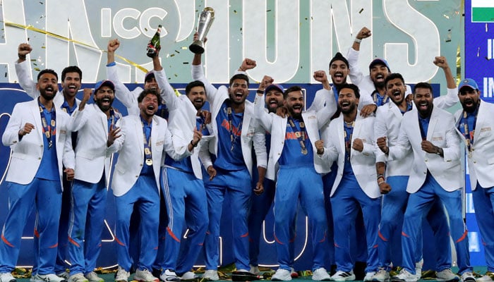 India players celebrate with the trophy on the podium after winning the ICC Mens Champions Trophy on March 9, 2025. —Reuters