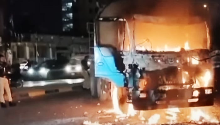 A cement mixer truck on fire after its driver killed a motorcyclist in Karachi, on March 21, 2025. — Screengrab/GeoNews