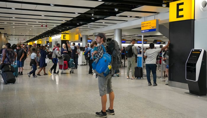 Passengers queue inside the departures terminal of Heathrow Terminal 3 in London, Britain, August 22, 2023. — Reuters