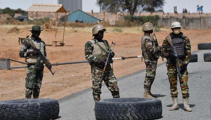 Nigerien soldiers stand guard outside the Diffa airport in South-East Niger, near the Nigerian border, on December 23, 2020. — AFP