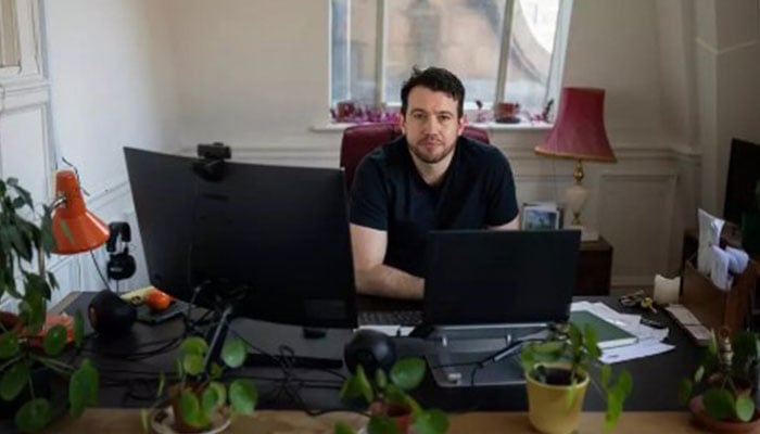 The Manchester Mill media founder and editor Joshi Herrmann works in the offices of the online newspaper serving Greater Manchester— AFP/File