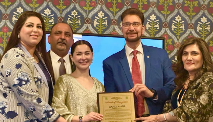 Acclaimed actress Hania Aamir (centre) receives the award during the ceremony at the UK Parliament. — Reporter